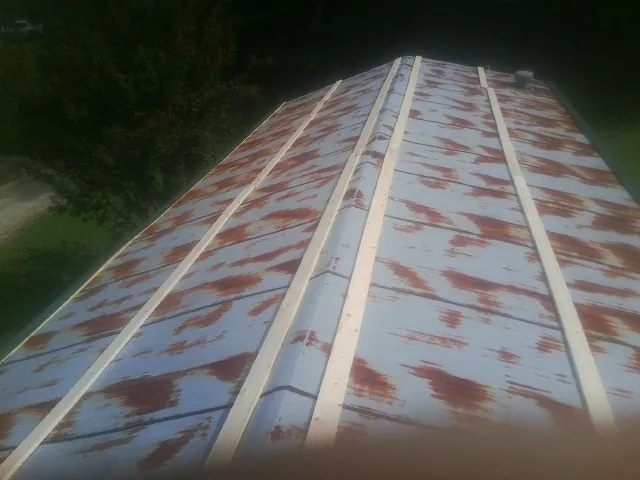 Rusted metal roof panels with new wood purlins before replacement — Storm Damage Roof Repair in Mooreton by Roofing Brothers