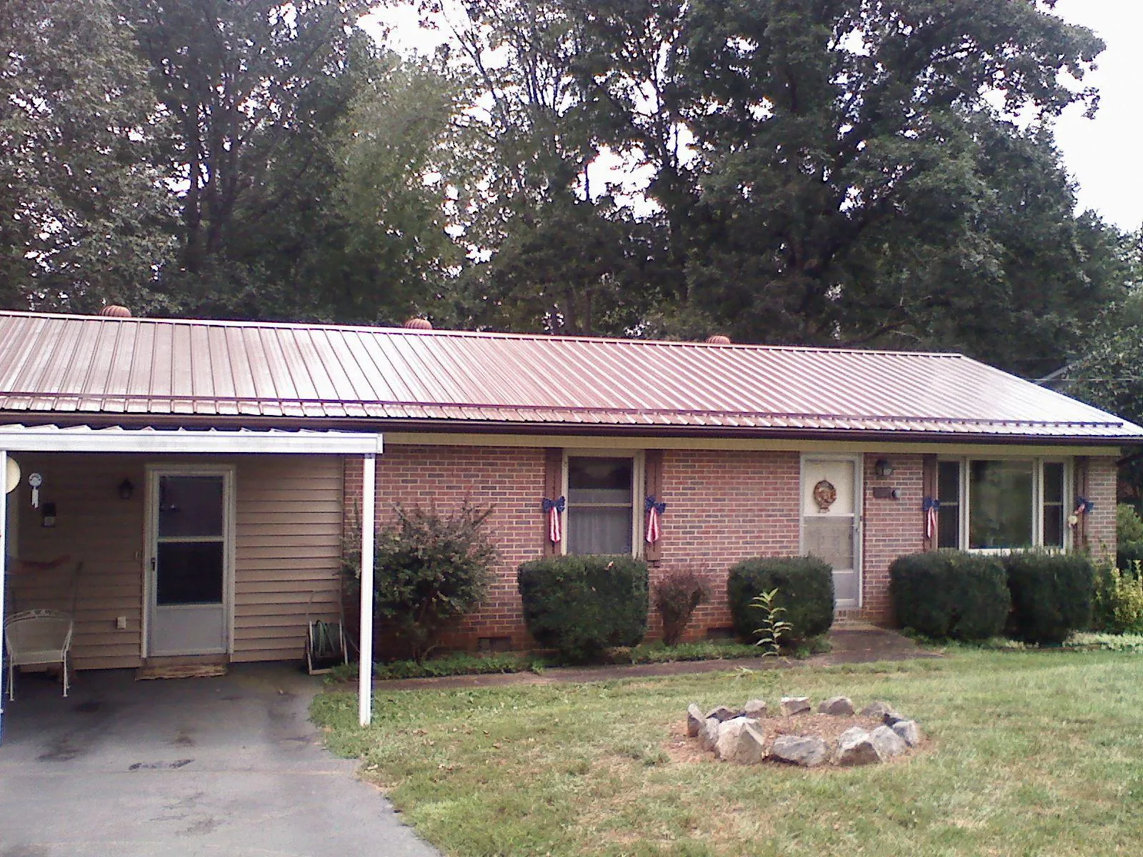 Bronze metal roof and carport on a brick ranch home — Roof Repair work by our crew in Mooreton