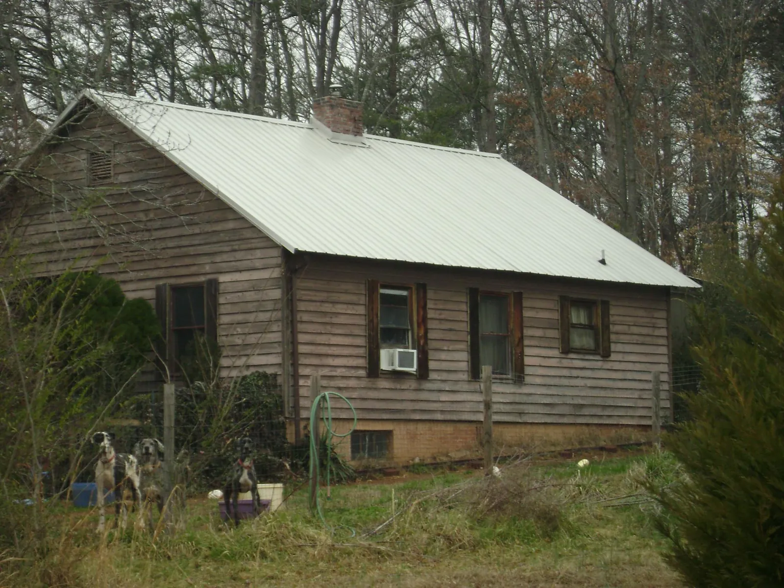 White metal roof on an old wood sided farmhouse, from a Metal Roof Installation job in Mooreton
